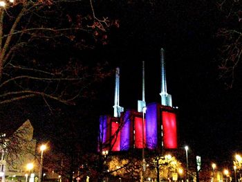 Low angle view of illuminated building against sky at night