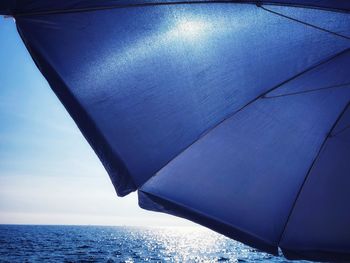 Close-up of sailboat in sea against sky