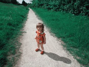 Portrait of cute girl standing on land