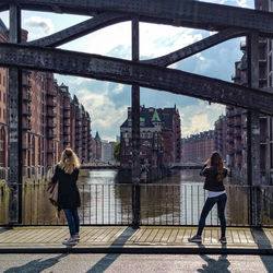 Woman standing on bridge over river