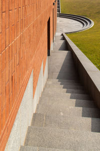 High angle view of staircase by footpath during sunny day