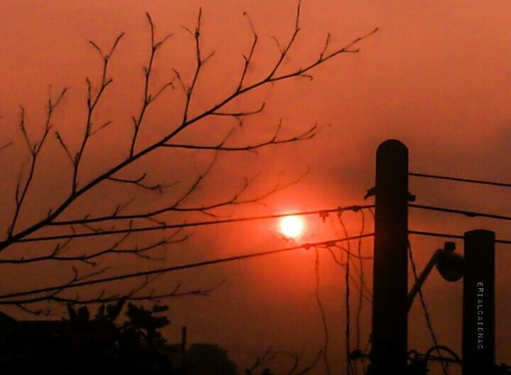 sunset, silhouette, sun, orange color, low angle view, sky, branch, bare tree, beauty in nature, nature, scenics, tranquility, tree, idyllic, outline, tranquil scene, outdoors, power line, electricity pylon, dramatic sky