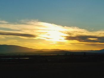 Scenic view of silhouette mountains against sky during sunset