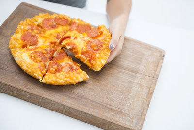 High angle view of pizza on cutting board
