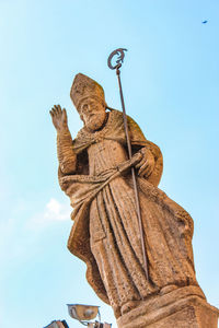 Low angle view of statue against clear blue sky