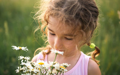 Cute girl smelling flowers