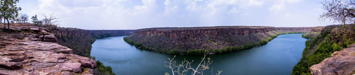 Panoramic view of river amidst rocks against sky