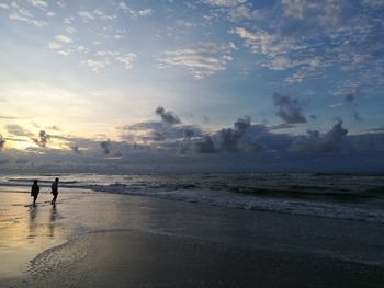 Scenic view of beach against sky during sunset