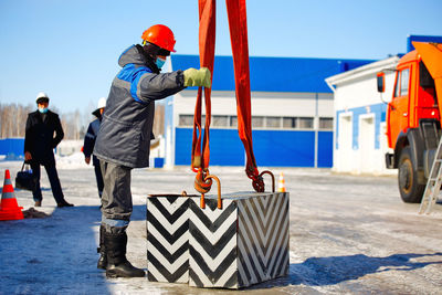 Rear view of man working at construction site