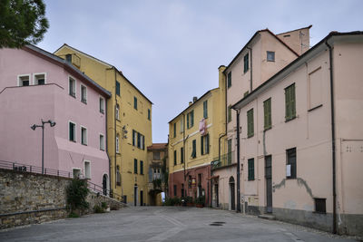 Street amidst buildings against sky