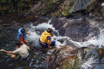 People enjoying in river at forest