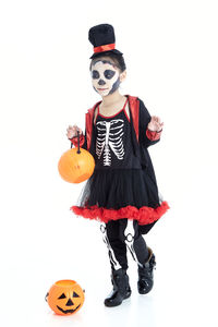 Full length of man holding pumpkin against white background