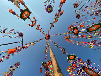 Low angle view of lanterns hanging against sky