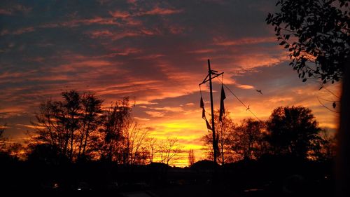 Low angle view of silhouette trees against sky during sunset