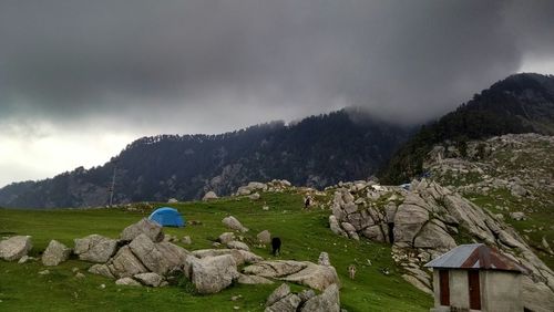 Scenic view of mountains against cloudy sky