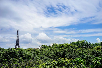 Eiffel tower against cloudy sky