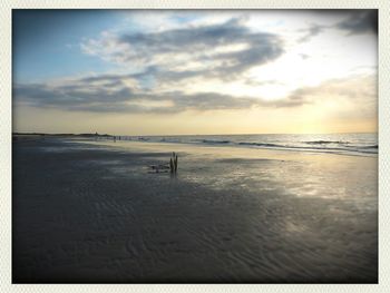 Scenic view of sea against cloudy sky