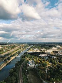 High angle view of cityscape against cloudy sky