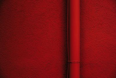 Pipe on red wall