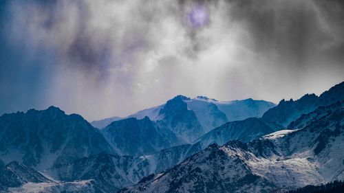 Scenic view of mountains against sky during winter