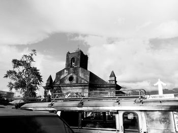 Low angle view of church against cloudy sky