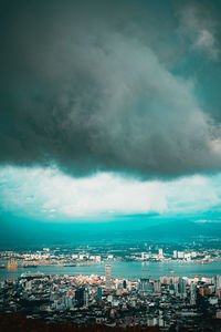 High angle view of cityscape against cloudy sky