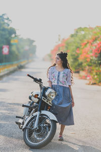 Young woman riding bicycle on road