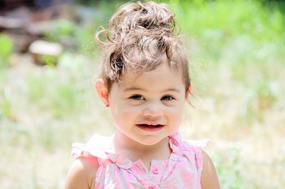 Close-up portrait of girl standing on field