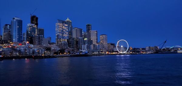 Seattle ferris wheel from the water at night