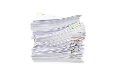 Close-up of paper stack against white background