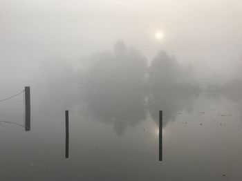 Scenic view of fog against sky during winter