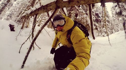 Close-up of man with umbrella on snow