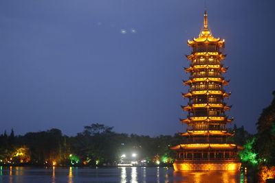 Illuminated building against sky at night