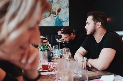 Young couple sitting on table at restaurant