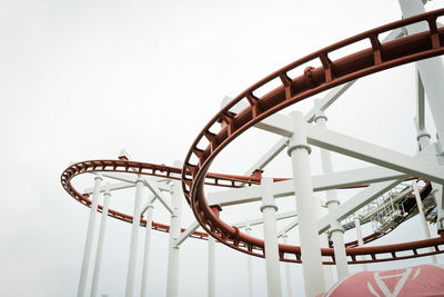 Low angle view of rollercoaster against sky