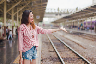 Full length of woman standing on railroad tracks