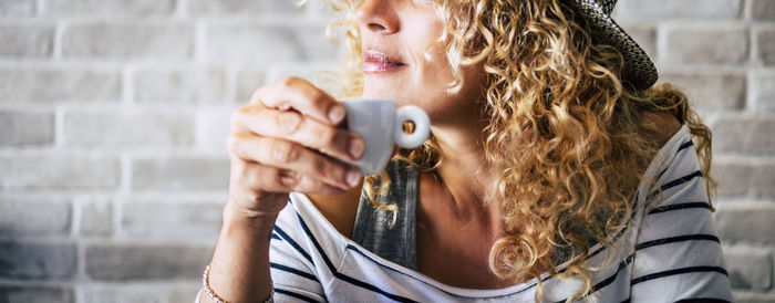 Midsection of woman drinking coffee