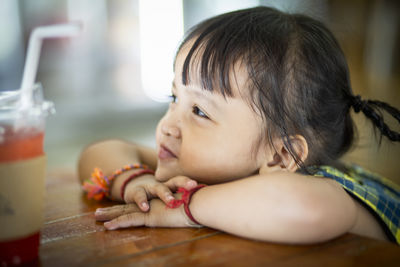 Close-up of cute baby girl at home