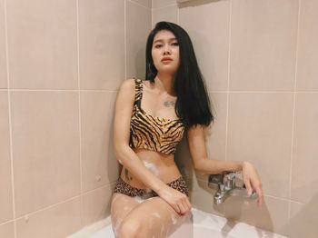 Beautiful young woman in bathroom