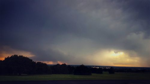 Scenic view of field against sky during sunset