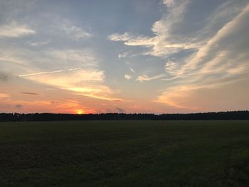 Scenic view of field against sky during sunset