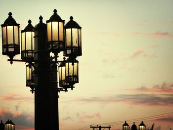 Low angle view of street light against sky at sunset