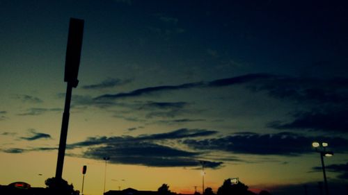 Low angle view of street light against sky at dusk