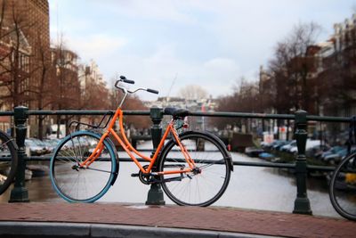 Bicycle parked by railing in city