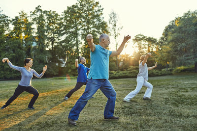 Group of people doing tai chi in a park