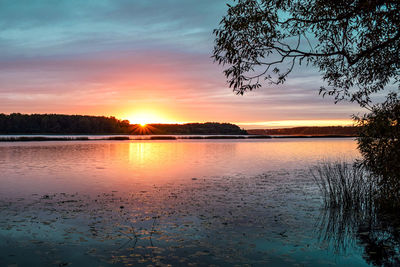 Scenic view of lake against orange sky