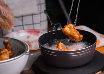 Close-up of meat in cooking pan on table