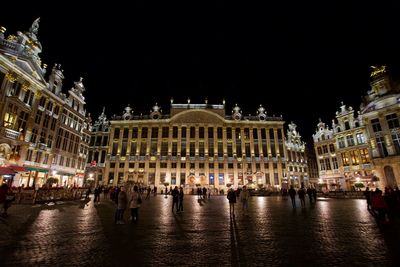 Group of people in front of building at night