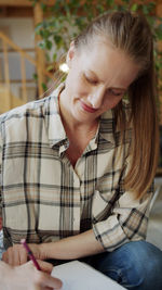 Close-up of young woman using mobile phone