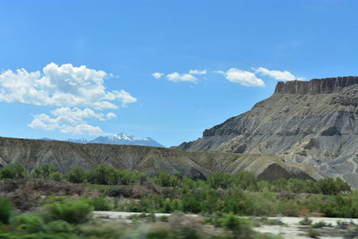 Scenic view of mountains against blue sky